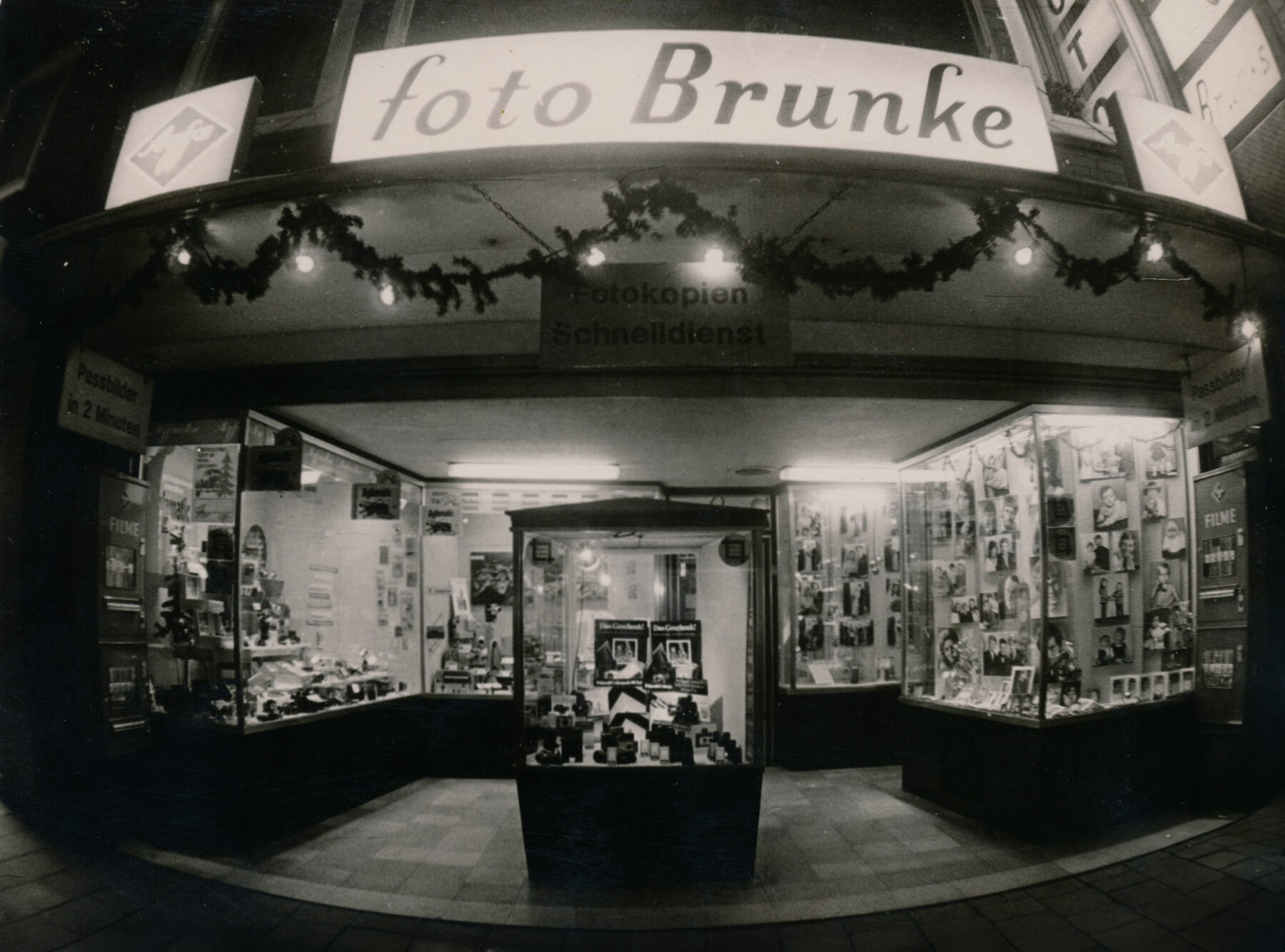 Weihnachtlich geschmücktes und beleuchtetes Schaufenster von Foto Brunke im Jahr 1970, darüber der Leuchtschriftzug